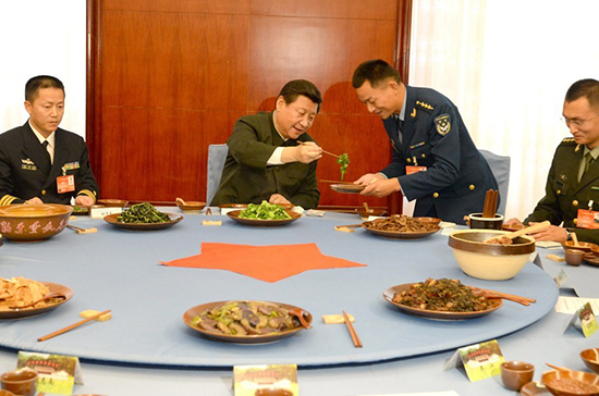 習(xí)近平與官兵吃“紅軍飯”,為官兵夾菜。據(jù)中國(guó)軍網(wǎng)/軍報(bào)記者
